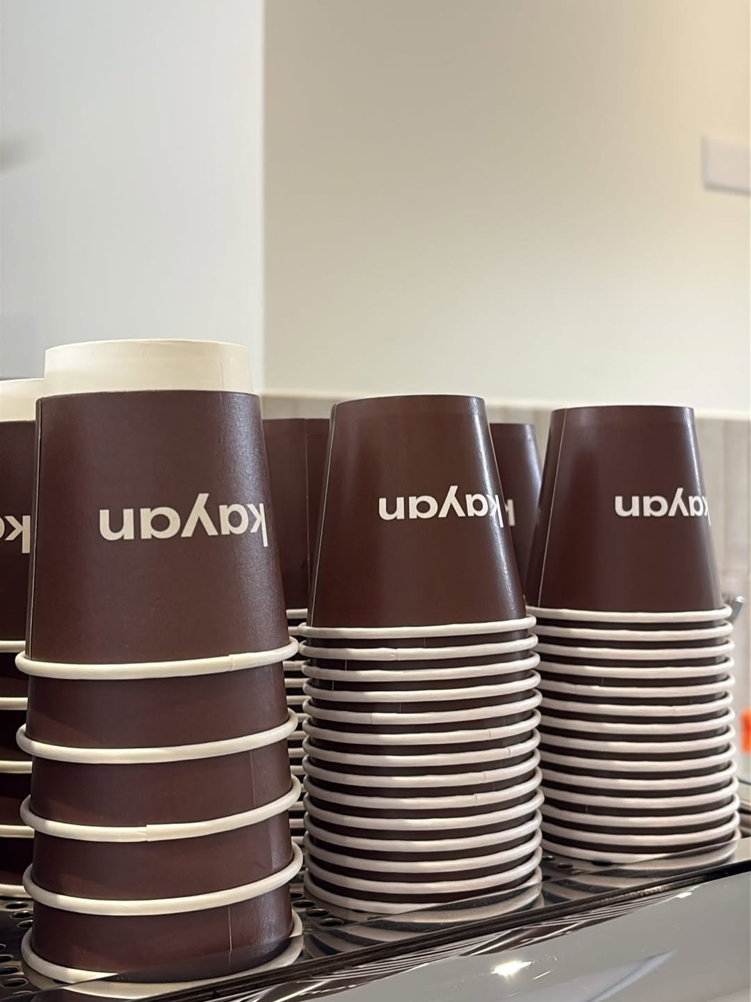Stacks of Kayan Coffee branded cups