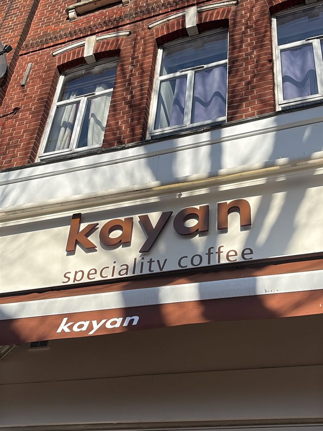 Kayan Coffee from the street — the warm brown signage above the door